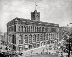 1904. "Produce Exchange, New York, N.Y." George Post's commodity exchange on Broadway, completed in 1884 and last seen here 11 years ago when it was the subject of this article in the New York Times, which recalled 19th-century criticism of the building's "preposterously projecting cornices” on "a very thin and stupid looking box." Note the ladders and scaffolds being used by a swarm of workers who seem to be cleaning its windows and brick facade. And, appropriately for a produce exchange, banana vendor pushcarts lined up out front. 8x10 inch dry plate glass negative, Detroit Photographic Company. View full size.