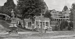 Circa 1910. "Lake Winnipesaukee, New Hampshire. The New Hotel Weirs and Soldiers' Monument." At the Weirs Bazaar (next to the memorial horse fountain), TEMPERANCE DRINKS and HELLGAMITE. 8x10 glass negative (cropped), Detroit Publishing Company. View full size.
