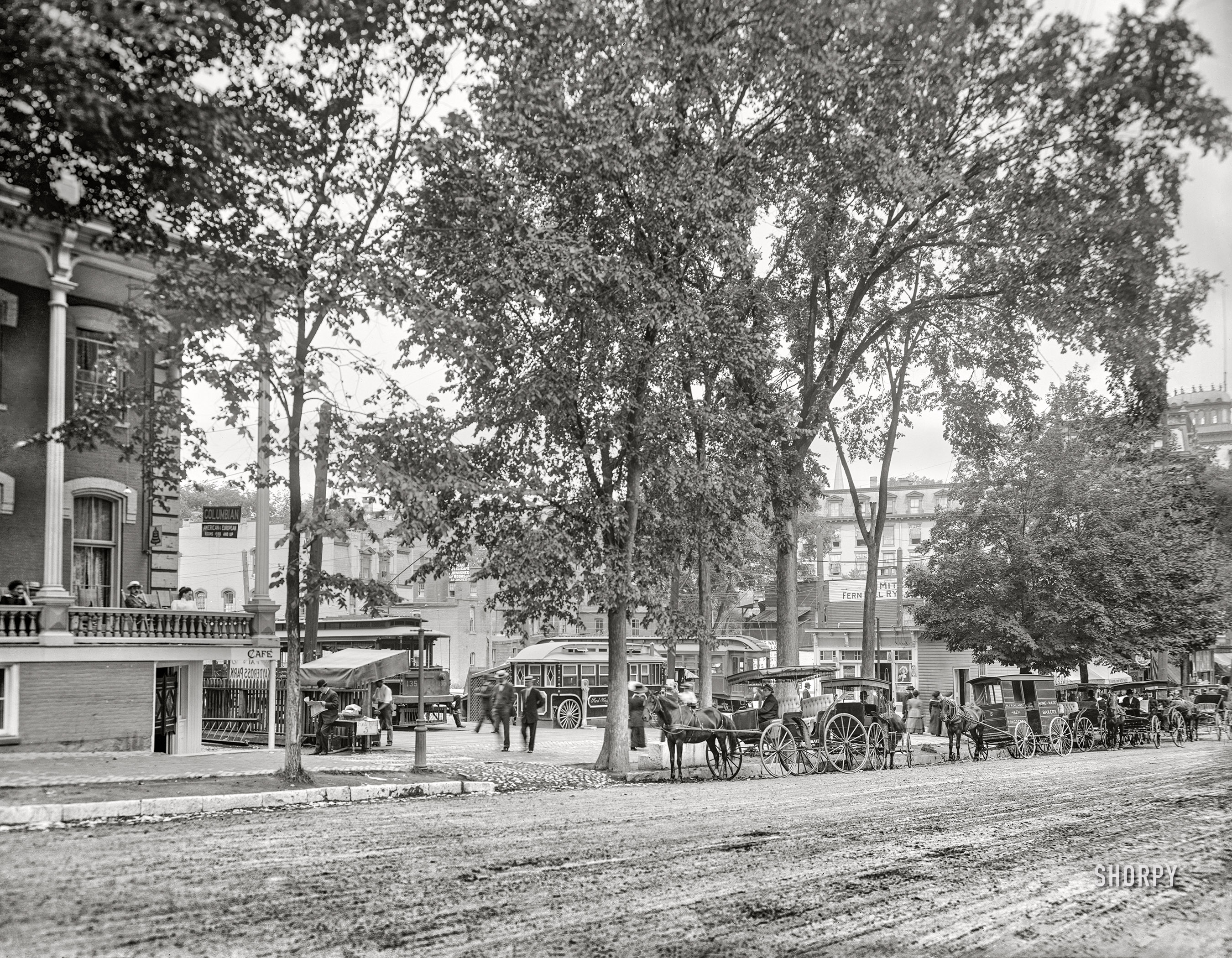 Saratoga Springs, New York, circa 1909. "The trolley station." Red-Hots only 5 cents! 8x10 inch dry plate glass negative, Detroit Publishing Company.