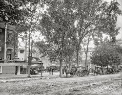 Saratoga Springs, New York, circa 1909. "The trolley station." Red-Hots only 5 cents! 8x10 inch dry plate glass negative, Detroit Publishing Company. View full size.
