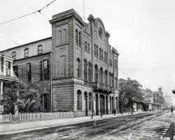 April 1910. "Washington Artillery Hall, St. Charles Avenue, New Orleans." With signs advertising a "Fancy Dress and Masquerade Ball" given by the Glad-U-Kum and Merry Widow social clubs on Shriners Night. View full size.