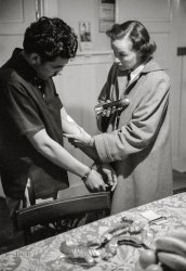 May 1955. "Los Angeles Policewoman of the Year Fransis Sumner questioning suspected drug user. Photographs show Officer Sumner working and training; questioning people; with children and infants; at jail with women prisoners; at firing range with other policewomen; in hand-to-hand combat class; in judo class; on obstacle course. Also photographs of Sumner receiving award; with husband at restaurant; at home knitting and cooking." 35mm negative by Earl Theisen from the Look magazine assignment "Police Woman." View full size.