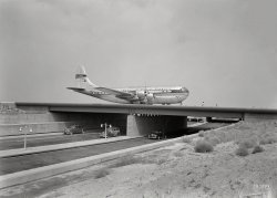 August 25, 1949. "New York International Airport, Idlewild. Bridge with plane." A Boeing 377 Stratocruiser, the Pan Am Clipper Seven Seas. Large-format acetate negative by Gottscho-Schleisner. View full size.