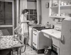July 1941. "War housing. Mrs. B.J. Rogan and her small son, Bernie, in the kitchen of the Rogans' new war home at the Franklin Terrace housing project in Erie, Pennsylvania. Mr. Rogan is a drill press operator at a nearby plant which is working three shifts on war contracts. The Rogans pay about twenty percent of their income for rent." Medium format acetate negative by Alfred Palmer for the U.S. Office for Emergency Management. View full size.