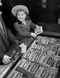 February 1943. Washington, D.C. "Preparation for point rationing. While Mother keeps handy her War Ration Book Two, daughter examines the frozen foods which require removal of point stamps." 4x5 acetate negative by Alfred Palmer, Office of War Information. View full size.
