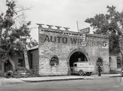 June 1939. "Blacksmith shop now used for auto repair. Glendive, Montana." A strong horseshoe motif here, architecturally speaking, in addition to the giant pile of actual horseshoes. Roofline of alphabetical anvils by Wile E. Coyote. "Wrecking" by "Joe Balison," who seems to be a fan of quote marks. Medium format negative by "Arthur Rothstein" for the "Farm Security Administration." View full size.