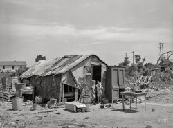 July 1939. "Shack of family living in May Avenue camp, Oklahoma City." Photo by Russell Lee for the Farm Security Administration. View full size.
