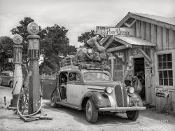 June 1940. "Stage in front of the post office at Pie Town, New Mexico. This stage comes through daily except Sunday. It takes in cream for the Pie Town farmers to Magdalena and Socorro and then returns the empty cans." Our second look at the Pie Town stop of the Socorro-Springerville Express. Medium format negative by Russell Lee. View full size.