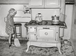 August 1940. "Daughter of Mormon farmer sweeping up the kitchen. Snowville, Utah." Acetate negative by Russell Lee for the Farm Security Administration. View full size.
