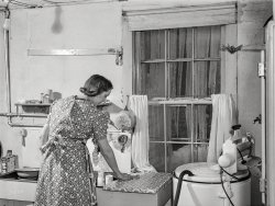 March 1940. "New England housewife fixing supper on a winter night. Woodstock, Vermont." Photo by Marion Post Wolcott for the Farm Security Administration. View full size.