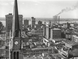 May 1940. "Downtown Louisville, Kentucky; Ohio River in background." Medium format negative by Marion Post Wolcott for the Farm Security Administration. View full size.