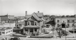 July 1940. "Brick house on main street of Benton Harbor, Michigan." This composite of two photos taken by John Vachon features "Kewpee Hamburgs" (last seen here) on the left; the previously unseen portion on the right stars a Texaco station and body shop. View full size.
