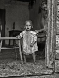 September 1940. "Near Dameron, Saint Mary's County, Maryland. Negro Farm Security Administration clients and their homes. Youngest of 11 children of Edward Gant family, FSA borrowers." Photo by John Vachon for the Farm Security Administration. View full size.