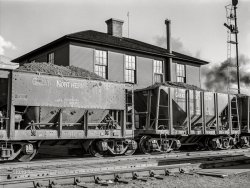 August 1941. "At the Great Northern Railroad yards, cars of iron ore passing over the scales are weighed at the rate of three and a half a minute. Superior, Wisconsin." Medium format acetate negative by John Vachon for the Farm Security Administration. View full size.