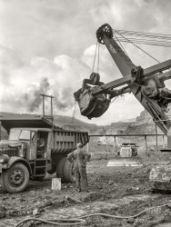&nbsp; &nbsp; &nbsp; &nbsp; Dart truck with Hercules dump body; Bucyrus-Erie 54-B electric shovel.
August 1941. "Loading dump truck with iron ore at the Albany mine, Hibbing, Minnesota.  Use of trucks was initiated in this mine two years ago and railroad tracks removed; trucks were found more economical and can climb the steep grade in much shorter time." Medium format acetate negative by John Vachon for the Farm Security Administration. View full size.