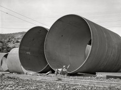 &nbsp; &nbsp; &nbsp; &nbsp; "INSTRUCTIONS: Grasping firmly, insert Segment 49E into 49F ... "
December 1941. Shasta County, California. "Segments of penstock pipe which will be used to conduct water from the reservoir formed by Shasta Dam to the hydroelectric turbines." Acetate negative by Russell Lee for the Farm Security Administration. View full size.