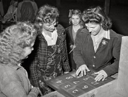 February 1942. Tulare County, California. "FSA farm workers' camp. Girls in the recreation room." Acetate negative by Russell Lee for the Farm Security Administration. View full size.