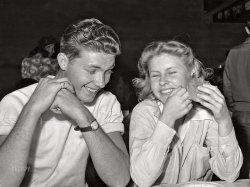 March 1942. El Centro, California. "Boy and girl at hamburger stand. Imperial County Fair." Acetate negative by Russell Lee for the Office of War Information. View full size.