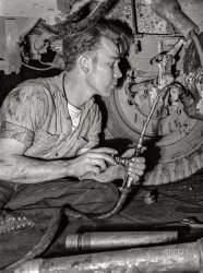 July 1942. "Grant County, Oregon. Malheur National Forest. Greasing a logging truck." Medium format acetate negative by Russell Lee for the Farm Security Administration. View full size.