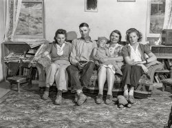 July 1942. "Ola, Idaho. FSA Ola self-help cooperative, adjacent timber stand, sawmill and farms. A member of the cooperative and his family at home. This man is a county commissioner." Photo by Russell Lee for the Farm Security Administration. View full size.