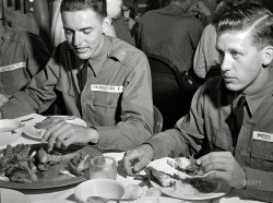 August 1941. "Poultry raised under FSA 'Food for Defense' program feeds Army flight trainees. Cadet E.A. Peresich Jr. takes his third helping of fried chicken. Craig Field, Southeastern Air Training Center, Selma, Alabama." Photo by John Collier, Farm Security Admin. View full size.
