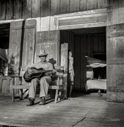 August 1940. "Farmer playing guitar on the porch in the evening. Near Natchitoches, Louisiana." Medium format nitrate negative by Marion Post Wolcott for the Resettlement Administration. View full size.
