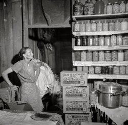August 1941. Coffee County, Alabama. "Josh Smart family participates in the FSA Food for Defense program. Mrs. Eulia Smart says: 'I never had a pressure cooker before, an' when I got this one, I canned everything in sight' -- 264 quarts since spring." Medium format nitrate negative by John Collier for the Farm Security Administration. View full size.