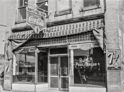 November 1939. "Runt's pool parlor with poster advertising Tobacco Ball in window. Zebulon, Wake County, North Carolina." Acetate negative by Marion Post Wolcott. View full size.