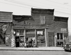 March 1936. Warren County, Mississippi. "Vicksburg Negroes and shop fronts." 8x10 inch nitrate negative by Walker Evans for the Resettlement Administration. View full size.