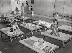 June 1942. "Queens, New York. Nursery school at Queensbridge housing project. Children listening to music during rest period." Acetate negative by Arthur Rothstein. View full size.