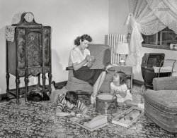 June 1942. "Brooklyn, New York. Red Hook housing development. Mrs. Caputo and her children in the living room of their four-and-a-half room apartment for which they pay $5.35 weekly." Acetate negative by Arthur Rothstein for the Office of War Information. View full size.