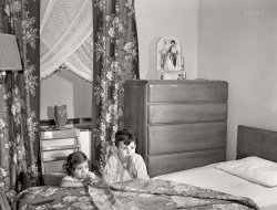 June 1942. "Brooklyn, New York. Red Hook housing development. Jimmy Caputo, 7 years old, and Annette, 4, at their nightly prayers." Acetate negative by Arthur Rothstein. View full size.