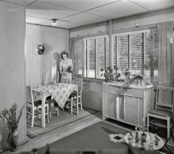 July 1942. "Middle River, Baltimore County, Maryland. Housing development for workers at the Glenn L. Martin aircraft plant. Living room and dining alcove." Porch Lady is back, pouring a nice glass of air in her Cemesto bungalow. Acetate negative by Marjory Collins. View full size.