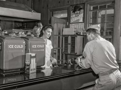 September 1942. "Fort Belvoir, Virginia. Sergeant George Camplair on one of his many visits to the post exchange." Acetate negative by Jack Delano, Office of War Information. View full size.