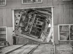 September 1942. Deer Lodge County, Montana. "Anaconda smelter, Anaconda Copper Mining Company. Cars containing 50 tons of copper ore are dumped by an unloading mechanism into a 200-ton hopper." Acetate negative by Russell Lee, Office of War Information. View full size.
