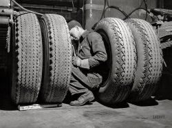 March 1943. "Baltimore, Maryland. Davidson Transfer Company trucking terminal. Checking the tires on truck tractors." Photo by John Vachon, Office of War Information. View full size.