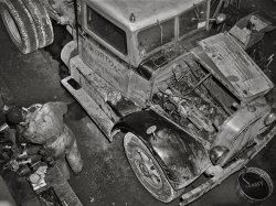 March 1943. "Baltimore, Maryland. Associated Transport Company trucking terminal. Truck service shop." Photo by John Vachon for the Office of War Information. View full size.