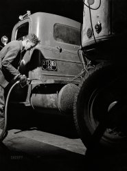 March 1943. "Truck transportation from Baltimore to New Orleans. Evergreen, Alabama -- refueling a Montgomery-to-Mobile truck at 3 a.m." Less than a hundred miles to go. Medium format acetate negative by John Vachon for the Office of War Information. View full size.