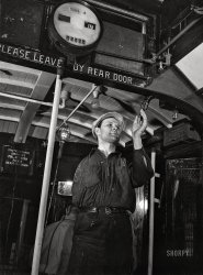 April 1943. "Baltimore, Maryland. One-armed painter, hired since the war, repainting the interior of a trolley at the maintenance terminal of the Baltimore Transit Company." Acetate negative by Marjory Collins for the Office of War Information. View full size.