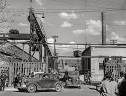 March 1943. "Santa Fe Railroad activities across New Mexico. Men coming out of the Atchison, Topeka, and Santa Fe Railroad shops in Albuquerque at the end of the day's shift." Acetate negative by Jack Delano for the Office of War Information. View full size.