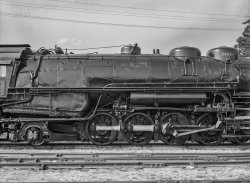 March 1943. San Bernardino, California. "A completely overhauled engine being run on the slip track at the Atchison, Topeka and Santa Fe Railroad shops. This is done to break the engine in. Note that due to the greased track, the engine is standing still while the wheels are spinning." Acetate negative by Jack Delano for the Office of War Information. View full size.
