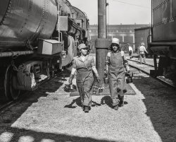 March 1943. "San Bernardino, California. Trinidad Gutierrez (left) and Molly Alcanto, women 'suppliers' who work at the Santa Fe roundhouse. Their job is replacing lamps and oil cans on incoming locomotives. Mrs. Gutierrez has four children. Her husband is in the hospital after an injury at the Kaiser Fontana steel mill. Miss Alcanto's boyfriend is in the Army." Acetate negative by Jack Delano for the Office of War Information. View full size.