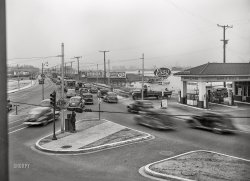April 1943. "Baltimore, Maryland. Transportation for war-swollen population. Traffic jam as workers of the first shift leave the Bethlehem Fairfield shipyards in cars and trolleys on the road to Baltimore." Photo by Marjory Collins for the Office of War Information. View full size.