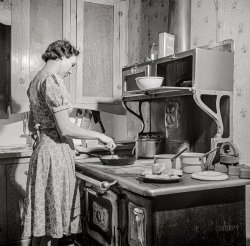 February 1943. "Moreno Valley, Colfax County, New Mexico. William Heck's wife getting supper." Nitrate negative by John Collier for the Office of War Information. View full size.