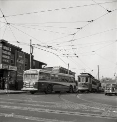 April 1943. Baltimore, Maryland. "Baltimore Transit bus with trolleys of 1917 vintage. Many old cars have been reconditioned because of wartime transportation pressure." Photo by Marjory Collins, Office of War Information. View full size.