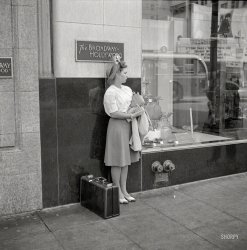 April 1942. "Hollywood, California. Girl on the street." Note the aspirational hat. Photo by Russell Lee for the Office of War Information. View full size.