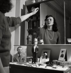 June 1943. "Arlington, Virginia. Mirrors over the dressing table conceal a cabinet which gives girls extra space for their cosmetics, etc., at Arlington Farms, a residence for women who work in the government for the duration of the war." Medium-format negative by Esther Bubley for the Office of War Information. View full size.