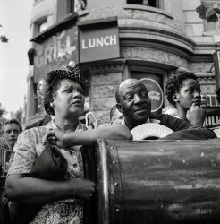 13,000 Win Applause in OCD Parade&nbsp; &nbsp; &nbsp; &nbsp; An estimated 150,000 spectators joined with approximately 13,000 marchers in the Civilian Defense parade last night in the opening of a drive for 22,000 civilian defense volunteers, giving Washington its largest demonstration of unity during the war, and by so doing served notice on the Axis that America's home front is well guarded.&nbsp; -- Washington Post, July 31, 1943
July 30, 1943. Washington, D.C. "Office of Civilian Defense. Spectators watching the parade to recruit civilian defense volunteers." Medium format nitrate negative by Esther Bubley for the Office of War Information. View full size.