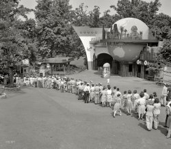&nbsp; &nbsp; &nbsp; &nbsp; Among the more than 50 attractions to be found at Glen Echo Park, the free admission amusement park and recreational center located at Glen Echo, Maryland, is the magnificent World Cruise Water Ride. Embarking at the entrance in boats seating six passengers, one is transported over a waterway to magnificent scenic views of the capitals of the world. Glen Echo Park is open each year from early April to the middle of September and is easily reached by De Luxe Capital Transit street cars, or Conduit Road auto highway, or auto straight out Massachusetts Avenue. Devoid of any objectionable features, Glen Echo Park is one of the points of interest of the National Capital. &nbsp; &nbsp; &nbsp; &nbsp; -- Postcard text, 1941
July 1943. Montgomery County, Maryland. "World Cruise at Glen Echo Park." Photo by Esther Bubley for the Office of War Information. View full size.