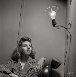 January 1943. Washington, D.C. "This Office of Price Administration clerk, speaking of her boardinghouse room, says: 'The light looks like an angel when I leave the shade off, so I do so'." Photo by Esther Bubley. View full size.